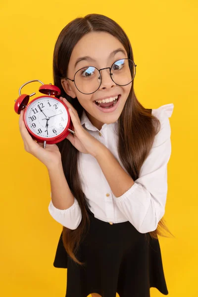 punctuality. last chance. punctual teen girl checking time. amazed nerd child listen the alarm clock ringing. school kid in uniform and glasses showing time. you are late. deadline. good morning.