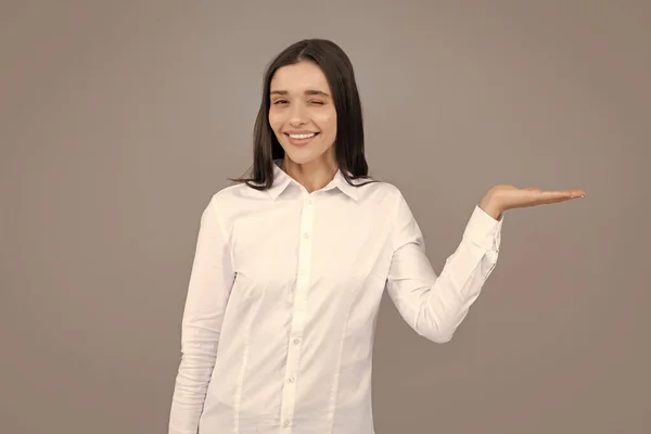 Woman point at copy space, showing copyspace pointing. Promo, girl showing advertisement content gesture, pointing with hand recommend product. Isolated background