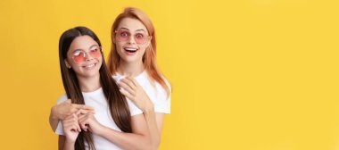 Mother and daughter child banner, copy space, isolated background. kid and mom. embracing mother and daughter in sunglasses