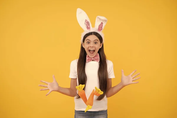 oh my god. happy childhood. cheerful bunny kid with carrot. happy easter holiday. funny child in rabbit ears. smiling teenager girl in bow tie. bunny hunt begin. just having fun. ready for party.