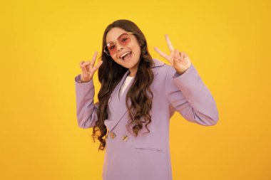 Amazed teen girl. Cute teen girl showing fingers doing victory sign. Number two, v sign, peace strength fight or victory symbol and letter v. Victory child teenager. Excited expression