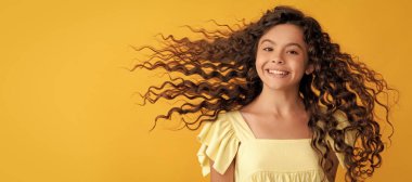 happy kid with long curly hair and perfect skin, volume hair. Child face, horizontal poster, teenager girl isolated portrait, banner with copy space