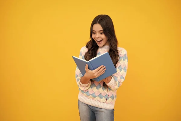 Excited face. Teen girl pupil hold books, notebooks, isolated on yellow background, copy space. Back to school, teenage lifestyle, education and knowledge. Amazed expression, cheerful and glad