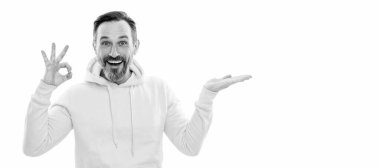 Man face portrait, banner with copy space. adult guy advertising. male casual sporty fashion. copy space. ok gesture. happy man pointing finger