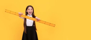 back to school. algebra and geometry. kid study math. measure the size. Portrait of schoolgirl student, studio banner header. School child face, copyspace