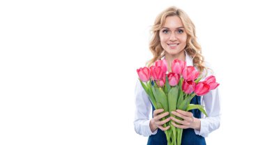 happy young woman in apron with spring tulip flowers isolated on white background.