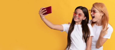 Mother and daughter child banner, copy space, isolated background. having video call. mother and daughter vlogging. online communication