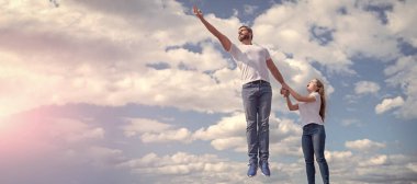 Father and daughter jumping in sky, banner poster with copy space
