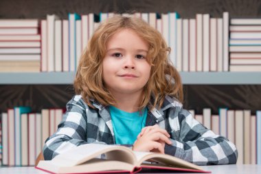 Child reading book in a book store or library