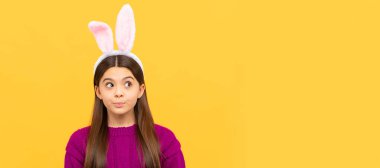 thoughtful teen child in easter bunny ears, easter holiday. Easter child horizontal poster. Web banner header of bunny kid, copy space