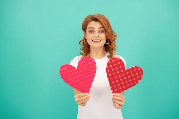 romantic present. young girl with red heart on blue background.