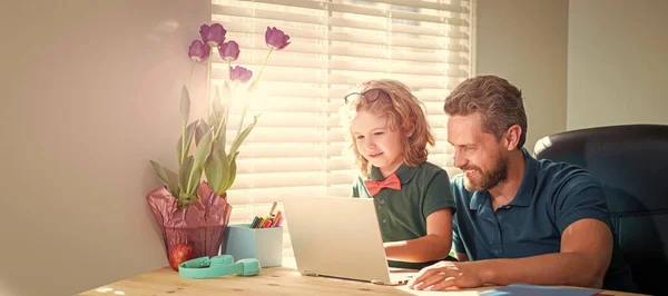 Banner of home school of father and son with laptop at home, happy daddy or teacher helping his school son kid in glasses study with pc in classroom, family.