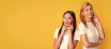 Mother and daughter kid banner, copy space, isolated background. mother and daughter speaking using modern smartphone, communication