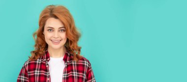 Woman isolated face portrait, banner with mock up copyspace. happy redhead woman in checkered shirt. express positive emotions. smiling lady with curly hair