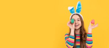 happy easter. childhood happiness. child in rabbit ears hold painted eggs. time for fun. Easter child horizontal poster. Web banner header of bunny kid, copy space