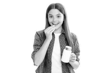 Child girl with pill. Taking medicine, vitamin supplements, treatment concept. Complete multivitamin. Kids healthcare and health. Portrait of happy smiling teenage child girl