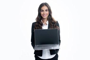 Beautiful smiling business woman over grey background using laptop computer. Woman holding laptop with empty mock up screen for copy space