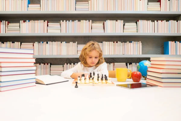 Chess school. Kid think about chess game. Child education concept. Intelligent, smart and clever school kids