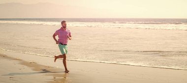 Man running and jumping, banner with copy space. healthy man running on beach. energetic summer. runner feel freedom. enjoying the morning