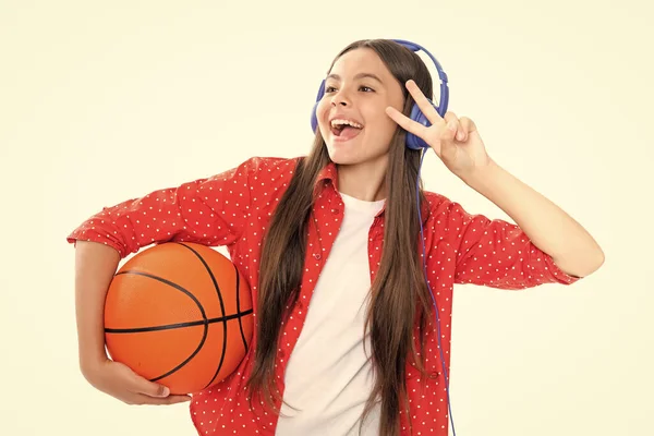 Portrait of emotional amazed excited teen girl. Teenager school girl with basketball ball