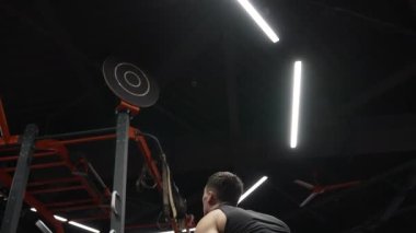 Formda adam spor salonunda ağırlık topuyla egzersiz yapıyor. Topla antrenman yapan bir sporcu. Jimnastik. Formunu geliştiriyor. Spor ve spor.