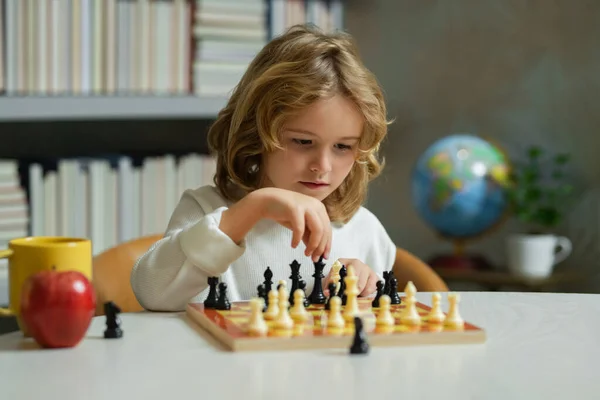 Early development. Boy thinking about chess. The concept of learning and growing children. Chess, success and winning. Logic game for kids and logical thinking