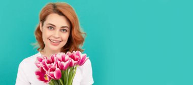 happy woman with tulip flower bouquet on blue background. mothers day. Woman isolated face portrait, banner with mock up copyspace