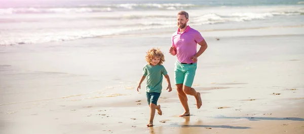 Banner of father and son run on summer sea beach. dad and child having fun outdoors. childhood and parenting. father and son.
