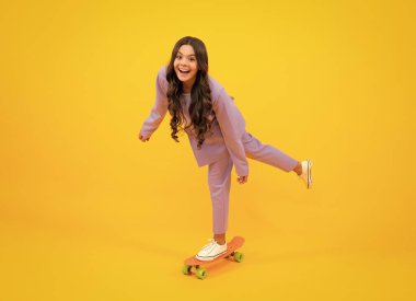 Teen hipster girl skater with skateboard on isolated background. Summer kids trend, urban teenage style