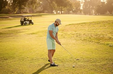 young man playing golf game on green grass, sports.