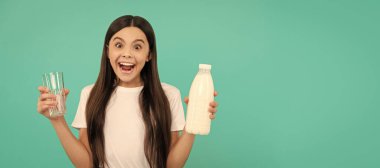 amazed kid hold glass and milk bottle. child hold dairy beverage product. Horizontal poster of isolated child face, banner header, copy space
