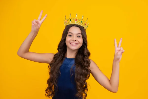 Teenager princess child celebrates success win and victory. Teen girl in queen crown. Happy girl smiling