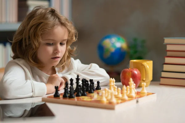 Brain development and logic. Early development. Boy thinking about chess. The concept of learning and growing children. Chess, success and winning