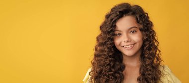 nice girl has wavy hairdo. portrait of frizz child. express positive emotion. Child face, horizontal poster, teenager girl isolated portrait, banner with copy space