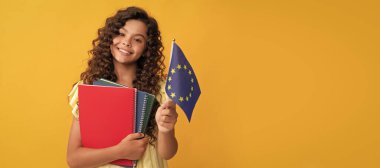 Okul kitaplarıyla mutlu genç kız eğitimi Avrupa sendikası bayrağı ve Schengen vizesi taşıyor. Öğrenci pankartı. Kopya alanı olan öğrenci portresi