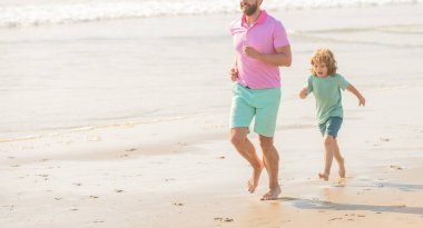 cropped father and son running on summer beach, copy space, summer.