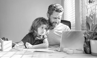 back to school. smiling father and son use computer at home. family and parenthood blog. boy do homework with teacher. webinar video lesson. online education on laptop. homeschooling and elearning.