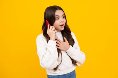 Portrait of cute teenage girl using mobile phone, chatting on web, typing sms message. Mobile app for smartphone. Surprised teenager girl