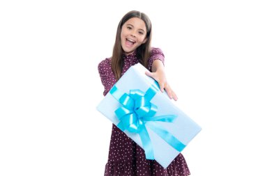 Child with gift present box on isolated studio background. Gifting for kids birthday. Portrait of emotional amazed excited teen girl