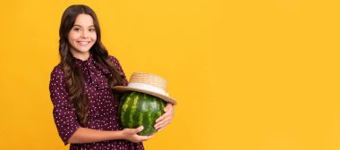 smiling kid holding fresh ripe water melon fruit in summer straw hat, health. Summer girl portrait with watermelon, horizontal poster. Banner header with copy space