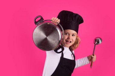 Fynny kid chef cook with cooking pot and ladle. Child in cook uniform. Chef kid isolated on pink background. Cute child to be a chef. Child dressed as a chef hat