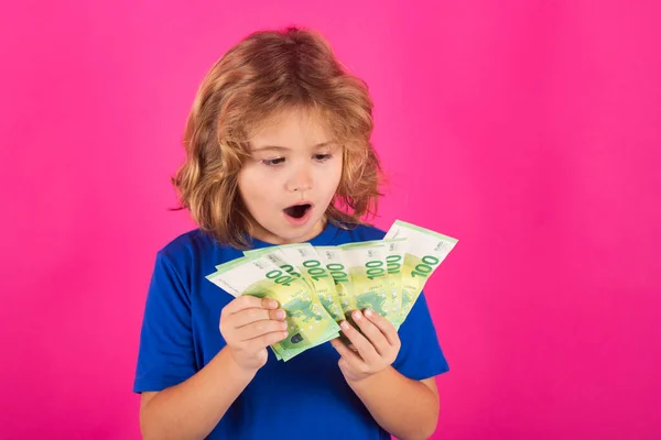 Cash money in dollar banknotes. Studio portrait of child with money banknotes. Kid with money for future. Children learning financial responsibility about saving money
