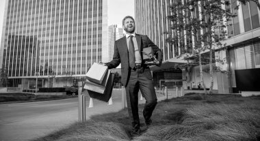 be my valentine. boxing day. handsome man with present box. entrepreneur carry birthday gift. guy hold shopping bags. mens day. glad businessman with packages. sale and discount. surprise for him.