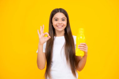 Girl holds water bottle. Kid girl care body hydration. Active leisure and water balance. Active and healthy kid drink water. Staying hydrated. Happy teenager portrait. Smiling girl