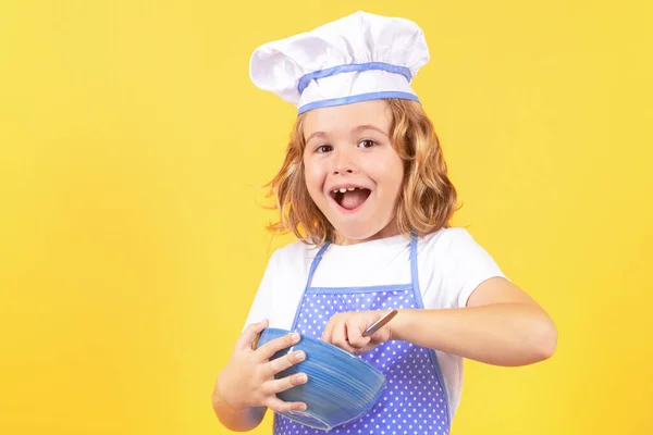 Kid chef cook with cooking bowl. Child chef cook, studio portrait. Kids cooking. Teen boy with apron and chef hat
