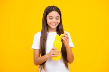 Child teen with water bottle isolated studio background. Water bottle and healthy life. Health and water balance. Happy teenager portrait. Smiling girl