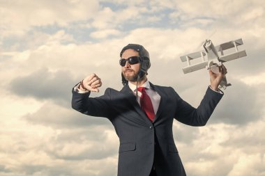 Takım elbiseli iş adamı ve pilot şapkalı uçak oyuncağı. kontrol zamanı.