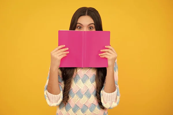 stock image Back to school. Teenager schoolgirl with book ready to learn. School girl children on isolated yellow studio background