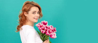 Woman isolated face portrait, banner with mock up copyspace. happy girl with tulip flower bouquet on blue background. mothers day