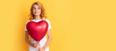 dreamy redhead girl with love heart balloon. charity and donation. Beautiful woman isolated face portrait, banner with mock up copy space